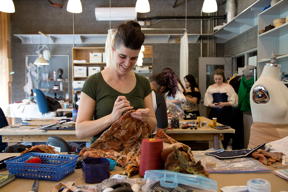 Student sewing in costuming studio